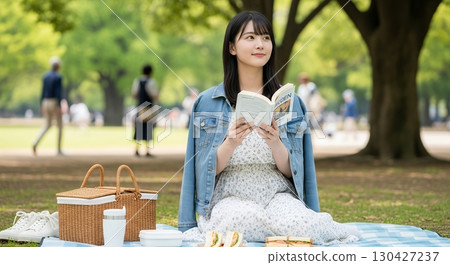 A woman relaxing in the park A woman relaxing in the park 130427237