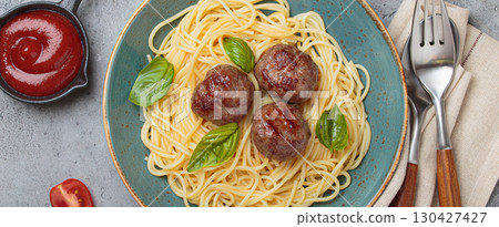 Delicious spaghetti with meatballs on plate, tomato sauce and basil on gray background top view 130427427