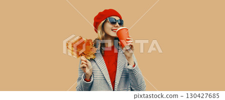 Autumn portrait of beautiful smiling young woman with yellow leaves, cup of coffee drink 130427685