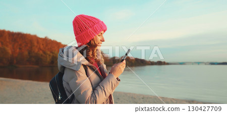 Travel, adventure, traveler woman with phone on the beach, girl holding smartphone on sea coast 130427709
