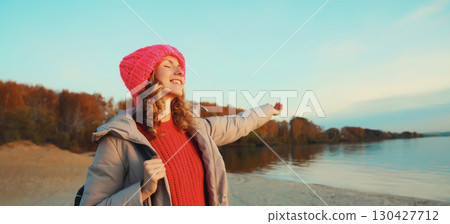 Travel, adventure, traveler woman on beach at sunset, enjoying landscape, on sea coast background 130427712