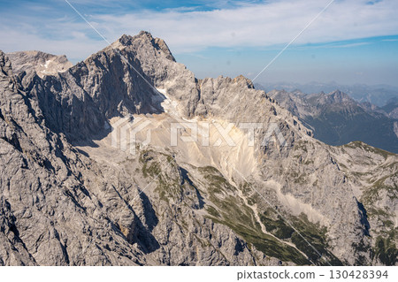 Scenic View Of Zugspitze And Jubilee Ridge From Via Ferrata Alpspitze: Rugged Rocky Peaks Of The Bavarian Alps Under Clear Blue Sky 130428394