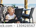 Girl child in a stroller in a restaurant on vacation 130428567