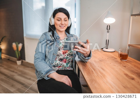 Young woman attending a video call while working from home 130428671