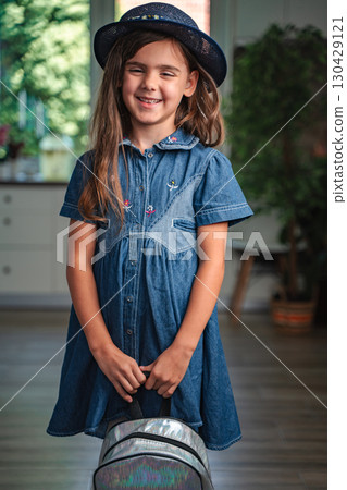 Smiling student girl holding her backpack ready for school 130429121