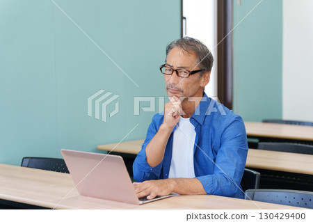 Senior man thinking using a computer 130429400
