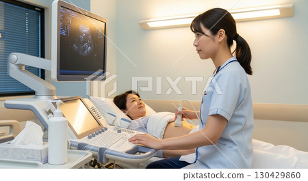 A female nurse performing an abdominal ultrasound examination on a woman A female nurse performing an abdominal ultrasound examination on a woman 130429860