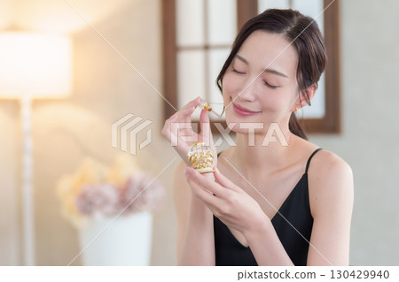 Woman holding a perfume bottle Woman holding a perfume bottle 130429940