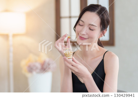 Woman holding a perfume bottle 130429941