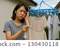 Woman hanging out laundry 0025 130430118