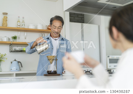 A man in his 60s making coffee 130430287