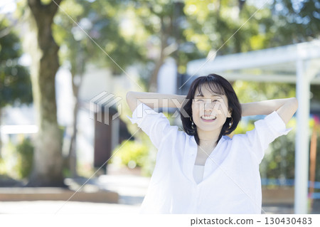 Middle-aged woman walking in the park Middle-aged woman walking in the park 130430483