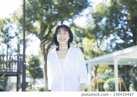 Middle-aged woman walking in the park 130430487