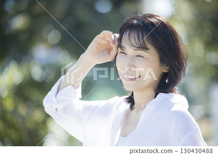 Middle-aged woman walking in the park 130430488