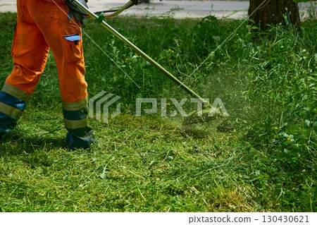 Landscaping.Professional grass cutting on green meadow with lawn mower 130430621