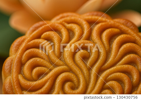 Close-up of mooncake carving showing intricate swirl pattern detail. Moon cake festival concept 130430756