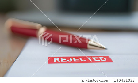Business form with large red REJECTED mark, symbolizing disappointment and rejection in professional settings. pen rests nearby, emphasizing formal context Business form with large red REJECTED mark, symbolizing disappointment and rejection in professional settings. pen rests nearby, emphasizing formal context 130431032