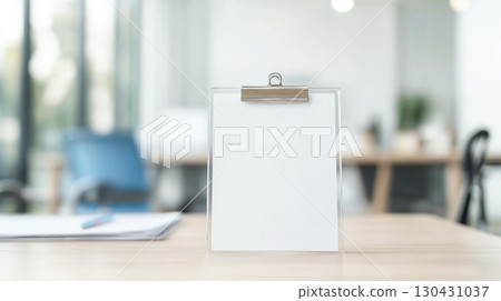 Blank clipboard on wooden desk in modern office setting, ideal for notes or presentations. clean design enhances productivity and organization 130431037