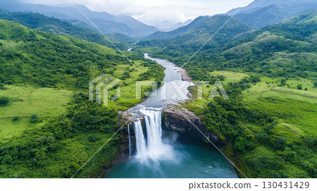 Landscape background Aerial view of stunning waterfall cascading into serene river, surrounded by lush green mountains and valleys. natural beauty evokes sense of tranquility and wonder 130431429