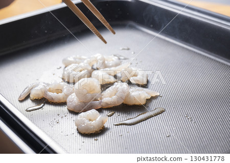 Fry shrimp on a hot plate 130431778