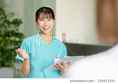 A young female doctor examining a patient A young female doctor examining a patient 130431933
