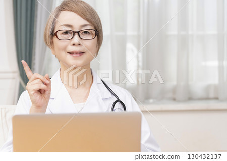 Female doctor in a white coat, senior veteran female doctor 130432137