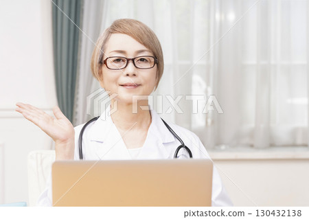 Female doctor in a white coat, senior veteran female doctor 130432138