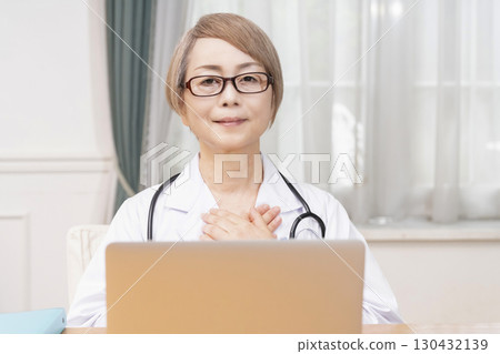 Female doctor in a white coat, senior veteran female doctor 130432139