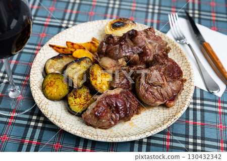 Tasty sliced grilled beef served with potatoes and eggplant 130432342