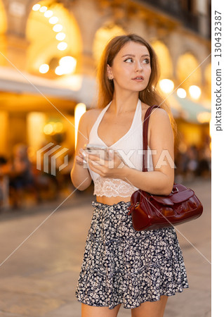 Woman walking around Barcelona, she has visited Placa real and plans to spend the evening in bars and restaurants with friends 130432387