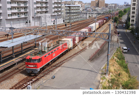 A freight train pulled by EF510 passing through Ashiya Station 130432398