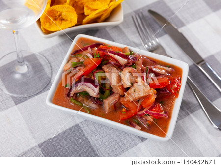 Ceviche served with fried banana in bowl 130432671