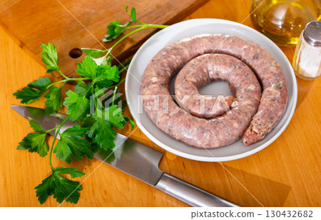 There is ring of homemade raw sausage made from meat mix 130432682