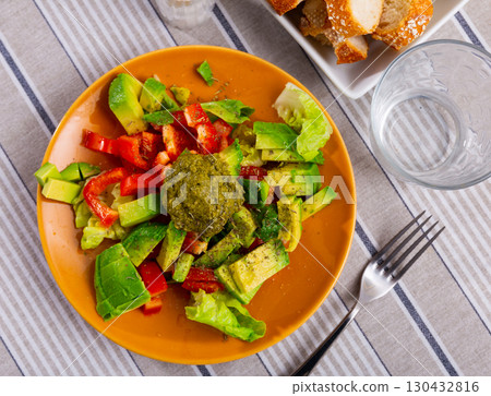 Salad with avocado and pesto sauce 130432816