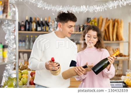 Couple man and woman choosing wine Couple man and woman choosing wine 130432839