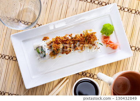 Plate is filled with crunch California rolls with fried puffed rice 130432849