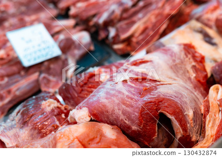 Cuts of raw beef in display case of butchery shop 130432874