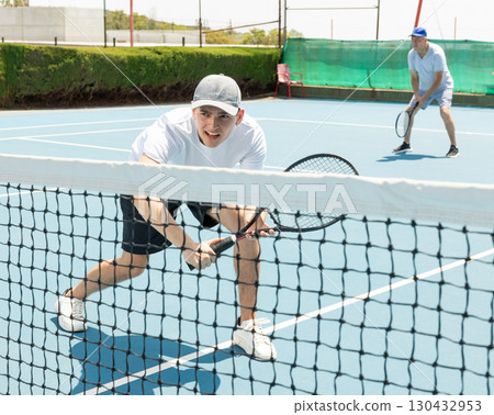 Tennis serve match on hard court 130432953