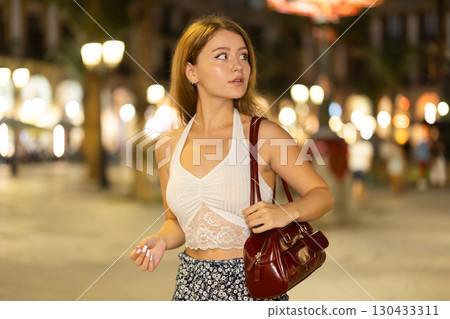 Woman walking around Barcelona, she has visited Placa real and plans to spend the evening in bars and restaurants with friends Woman walking around Barcelona, she has visited Placa real and plans to spend the evening in bars and restaurants with friends 130433311