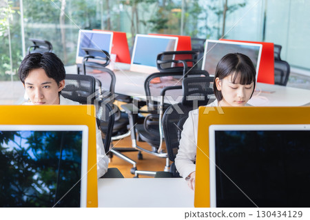 Business person working on a computer Business person working on a computer 130434129