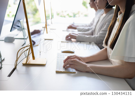 Business person working on a computer Business person working on a computer 130434131