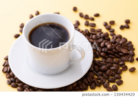 Hot coffee and coffee beans on the table Hot coffee and coffee beans on the table 130434420