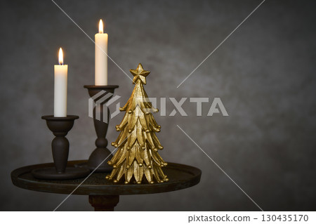 古董邊桌上擺放著聖誕樹和蠟燭 130435170