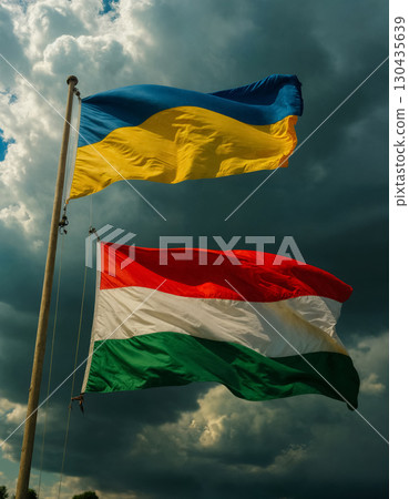 waving flags of ukraine and hungary against dark sky, political crisis concept 130435639