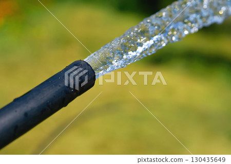 Hose with pouring water to water plants.Landscaping,gardening 130435649