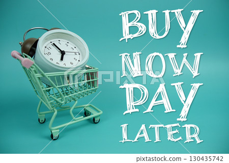 Buy Now Pay Later text with trolley shopping cart and alarm clock on blue background 130435742