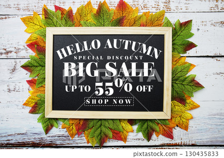 Hello Autumn Big Sale 55% with maple leaf decortaed on wooden background 130435833