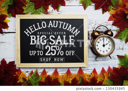Hello Autumn Big Sale 25% with maple leaf decortaed on wooden background Hello Autumn Big Sale 25% with maple leaf decortaed on wooden background 130435845