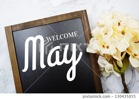 Welcome May text on blackboard with flowers decoration on marble background 130435855
