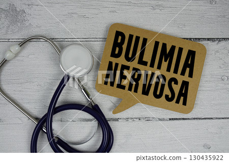 Bulimia Nervosa text with Stethoscope on wooden background Bulimia Nervosa text with Stethoscope on wooden background 130435922